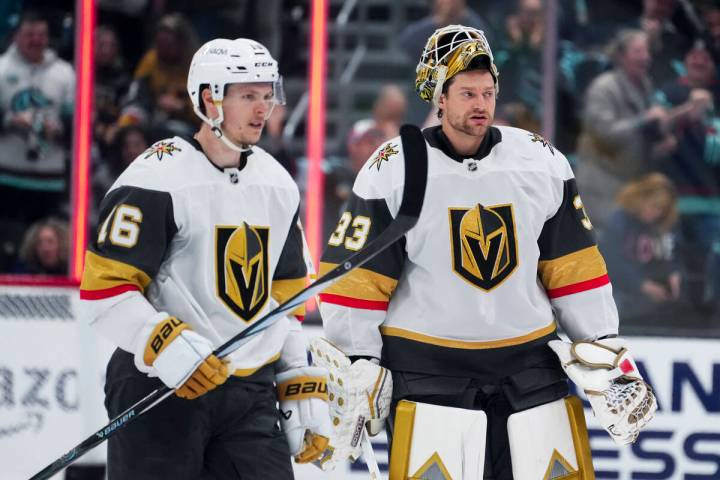 Vegas Golden Knights' Pavel Dorofeyev, left, and goaltender Adin Hill, right, react after losin ...