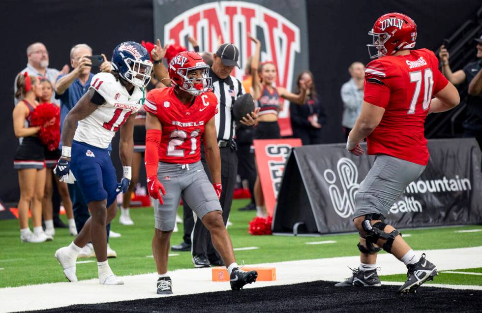 UNLV wide receiver Jacob De Jesus (21) celebrates after scoring a touchdown during the college ...