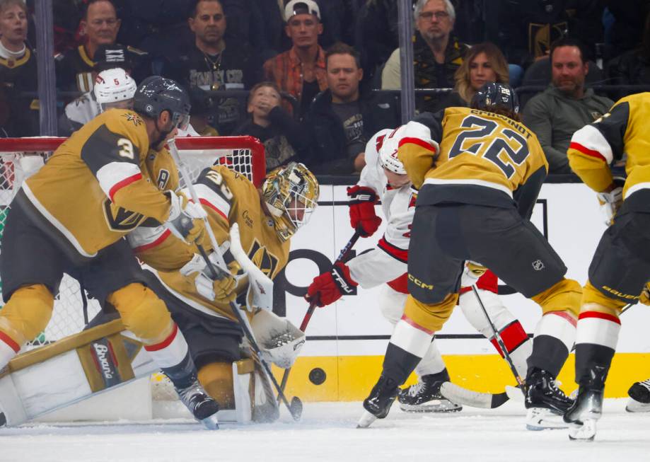 Golden Knights defenseman Brayden McNabb (3) and goaltender Adin Hill (33) defend the net as Ca ...