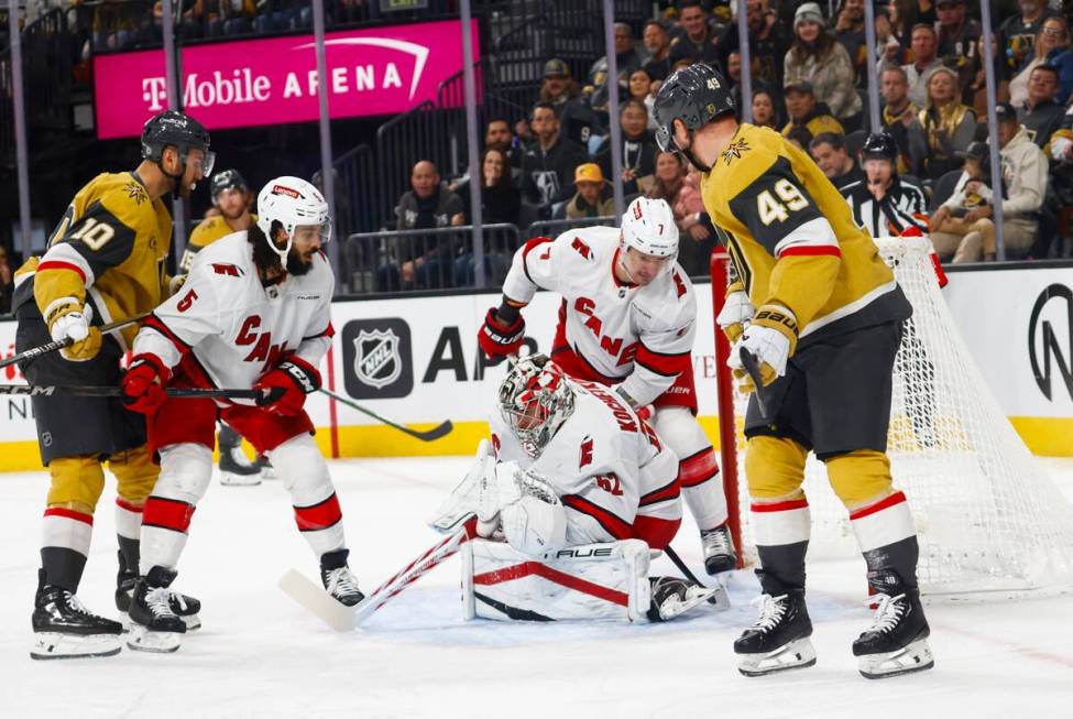 Carolina Hurricanes goaltender Pyotr Kochetkov (52) stops the puck against the Golden Knights d ...