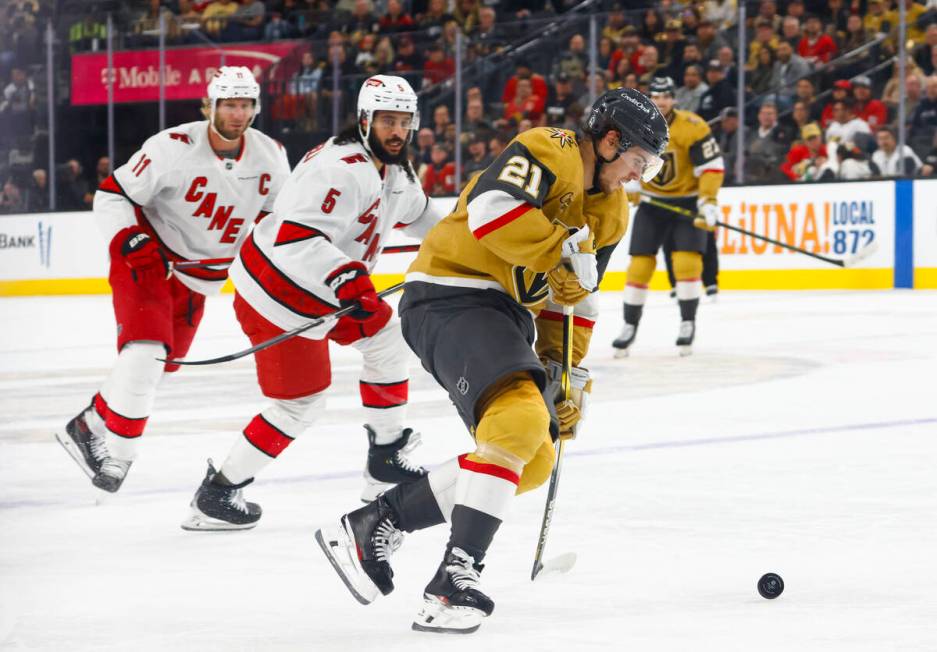 Golden Knights center Brett Howden (21) skates with the puck in front of Carolina Hurricanes de ...