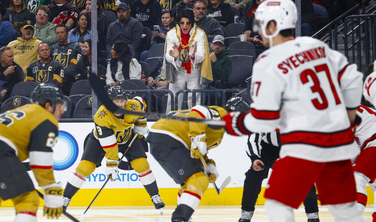 A man dressed as Elvis cheers for the Golden Knights during the third period of an NHL hockey g ...