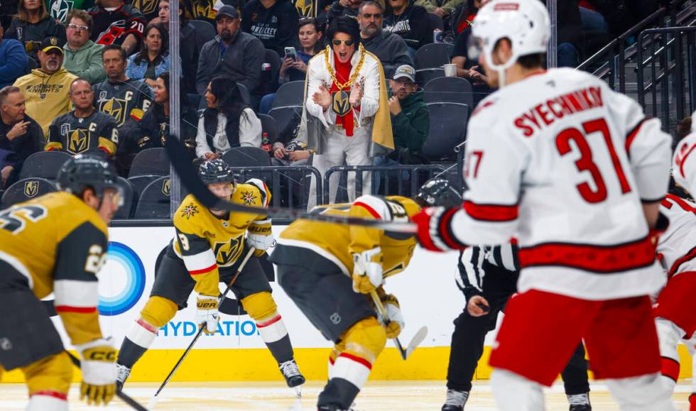 A man dressed as Elvis cheers for the Golden Knights during the third period of an NHL hockey g ...