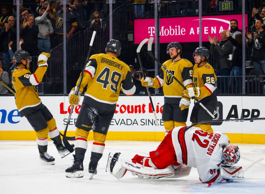 The Golden Knights celebrate after a goal against the Carolina Hurricanes during the third peri ...