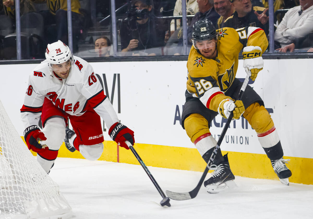 Golden Knights right wing Alexander Holtz (26) vies for the puck against Carolina Hurricanes de ...