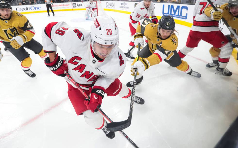 Carolina Hurricanes center Sebastian Aho (20) and Golden Knights center William Karlsson (71) f ...