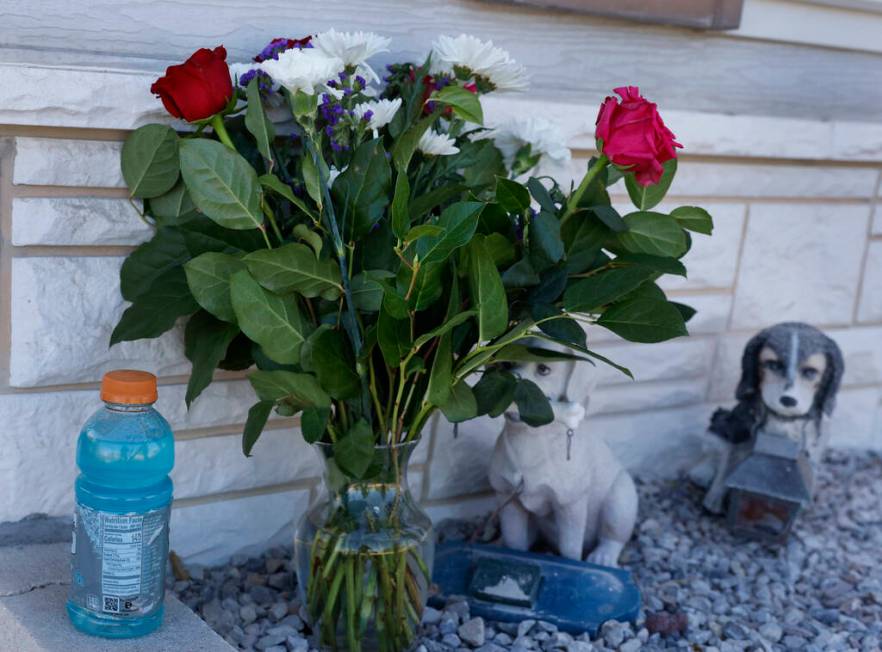 A lone bouquet of flowers in front of the house where Monique Gilbertson's body was found is se ...