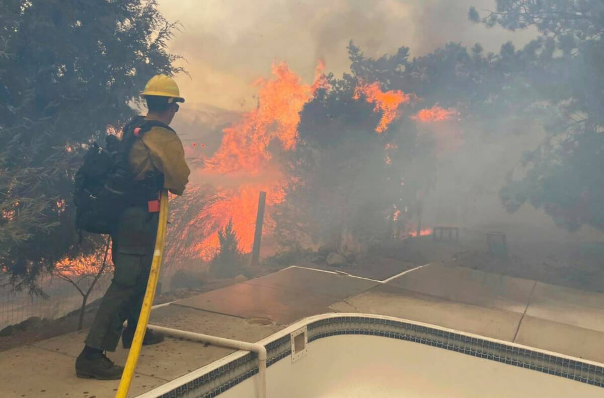 Fire crews battle the Callahan Fire, which caused the evacuations of hundreds of homes southwes ...