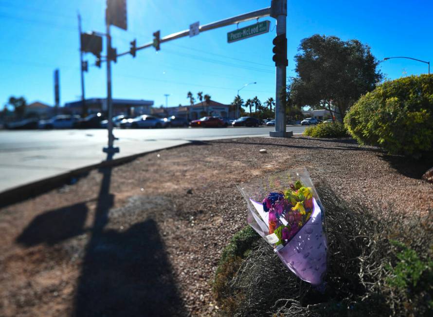 Flowers are placed at the scene of a fatal car accident at the intersection of Flamingo and Pec ...