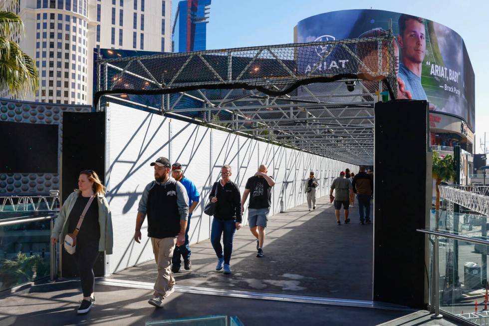 Pedestrians use the pedestrian bridge over Las Vegas Boulevard near the Cosmopolitan and Planet ...