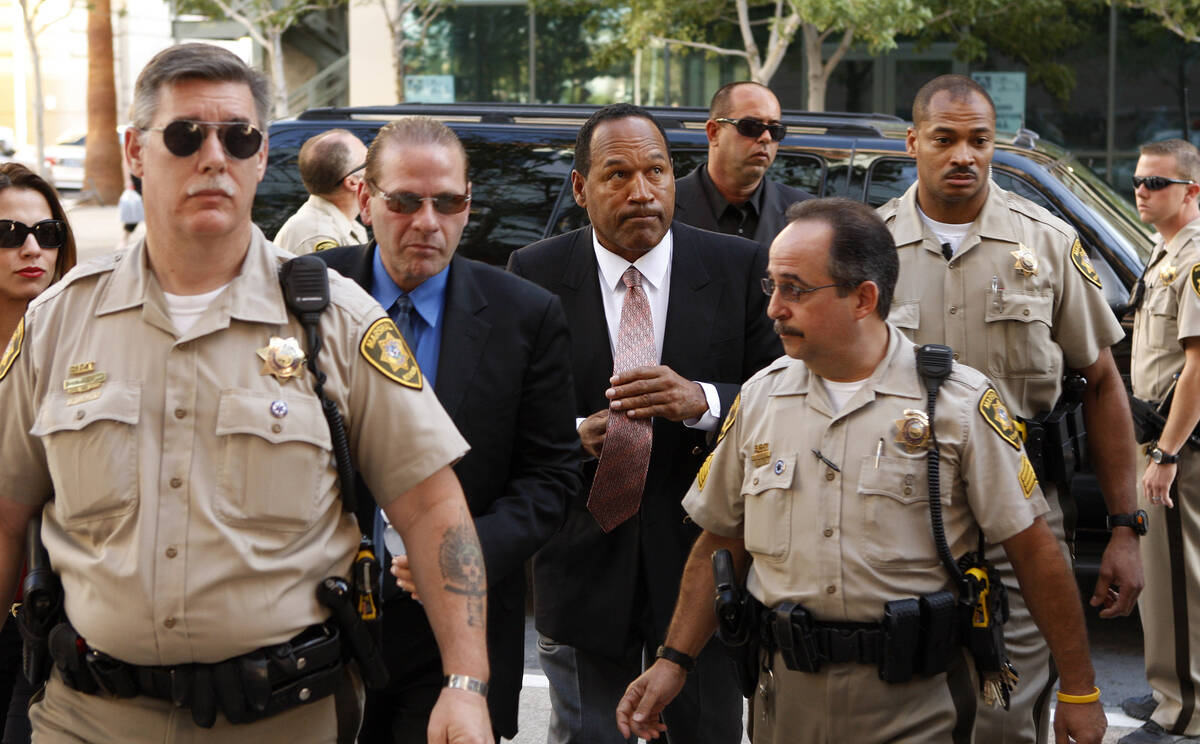 O.J. Simpson, center, arrives during the second day of jury selection for his trial at the Clar ...