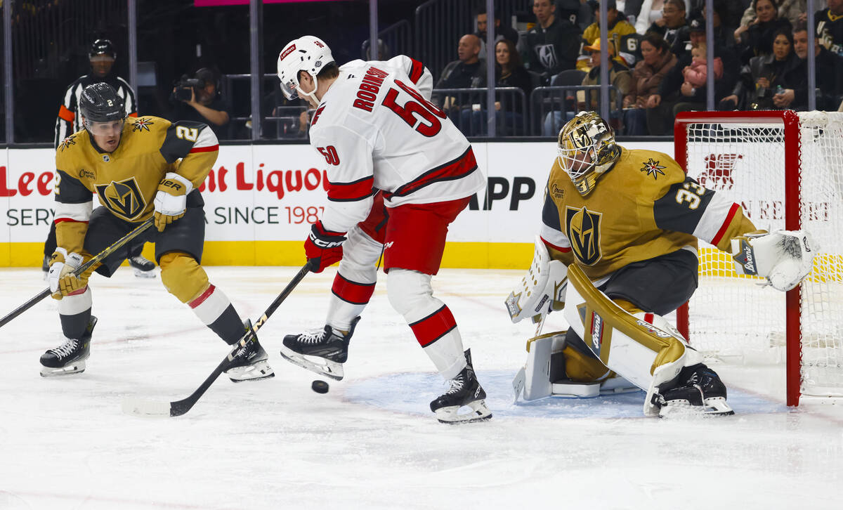 Golden Knights goaltender Adin Hill (33) and Golden Knights defenseman Zach Whitecloud (2) defe ...