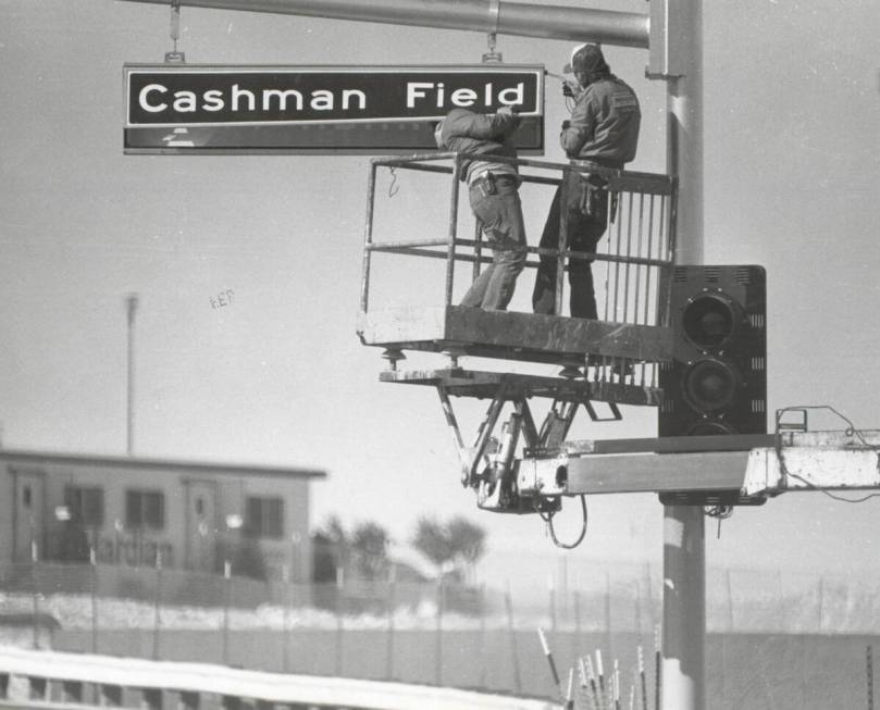 Workers install a Cashman Field street sign on Las Vegas Boulevard North before the center open ...