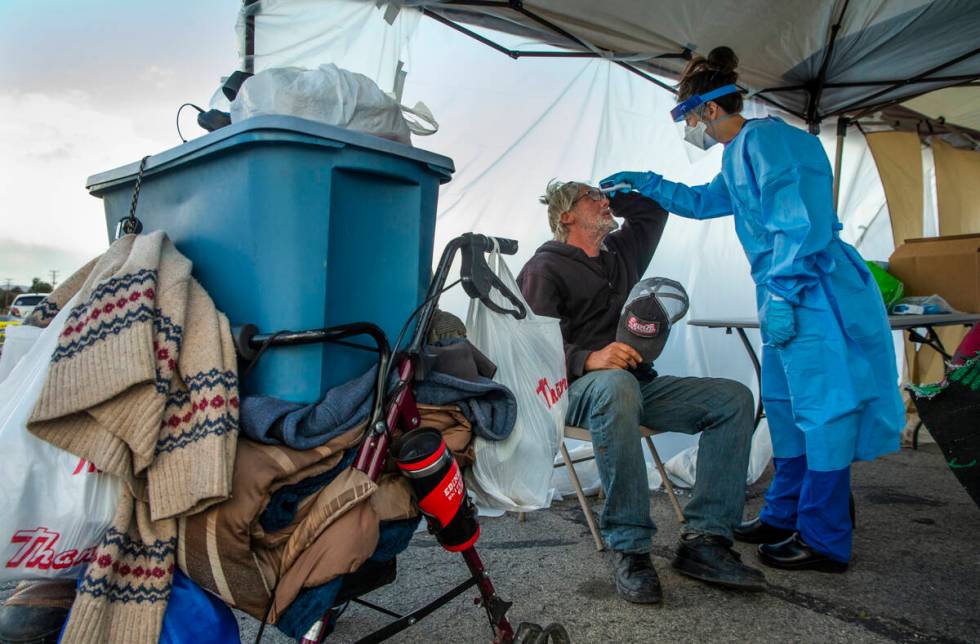 Touro University Nevada medical student Allison Moran, right, screens homeless man Gregory Hemm ...