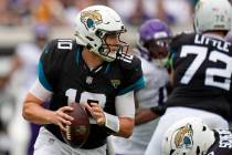 Jacksonville Jaguars quarterback Mac Jones scrambles against the Minnesota Vikings during the f ...