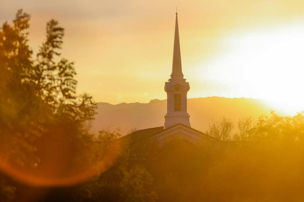 The sun sets behind The Church of Jesus Christ of Latter-day Saints on Aug. 23, 2024, in Hender ...