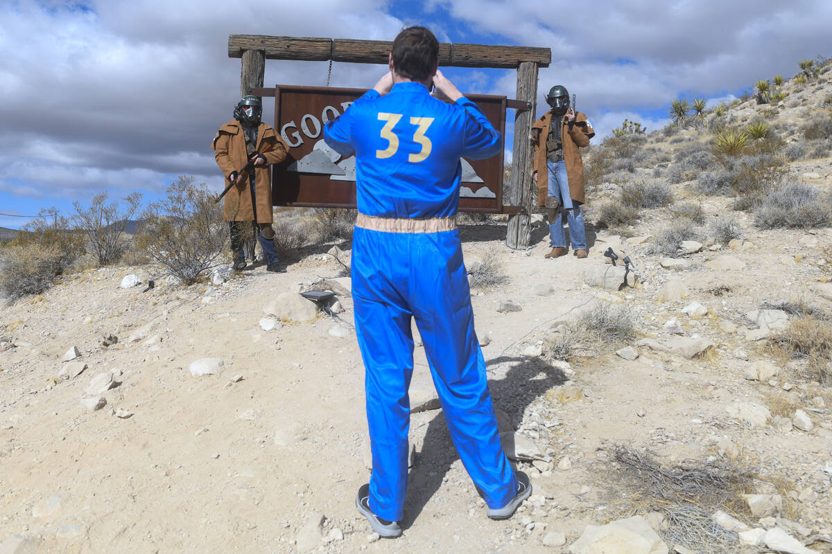 Attendees take a photo near the Goodsprings town sign during the Fallout Fan Celebration Saturd ...