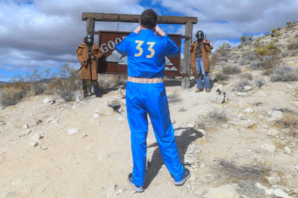 Attendees take a photo near the Goodsprings town sign during the Fallout Fan Celebration Saturd ...