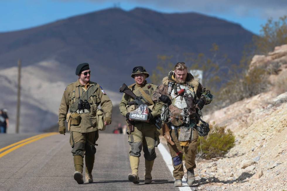 Attendees in costume walk down the road during the Fallout Fan Celebration Saturday, November 1 ...