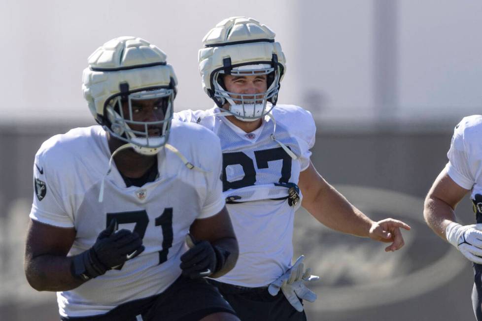 Raiders tight end Michael Mayer (87) warms up near offensive tackle DJ Glaze (71) during the te ...