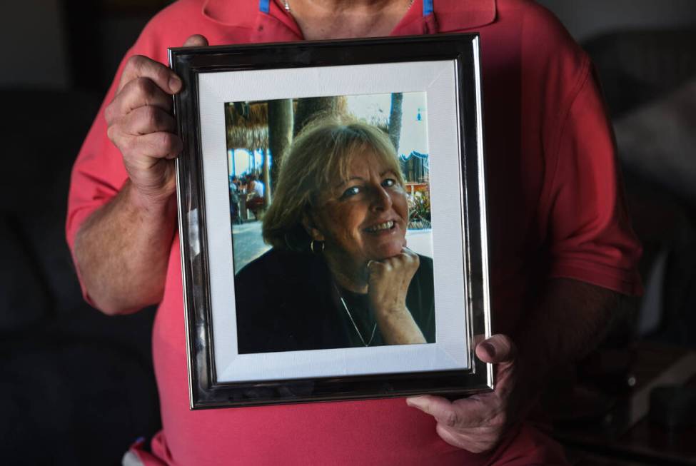 Tim Reiber holds a photo of his wife of nearly 30 years, Judy Reiber, at their home in Henderso ...