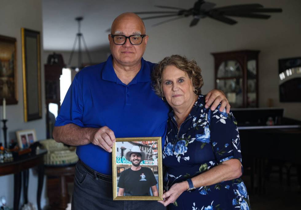 George Paprotny and his wife, Aimee, pose for a portrait as they hold a photo of their son Step ...