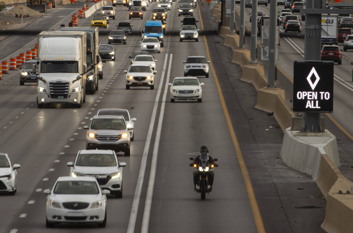 FILE - An HOV lane sign denotes that the lane is "open to all" as part of a pilot transportatio ...