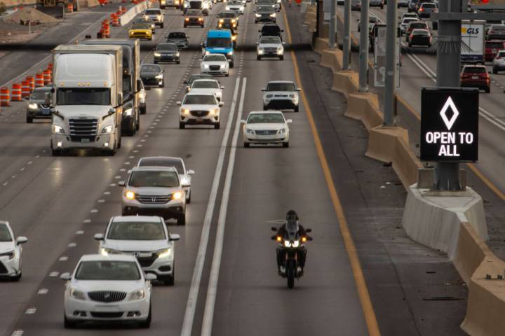 FILE - An HOV lane sign denotes that the lane is "open to all" as part of a pilot transportatio ...