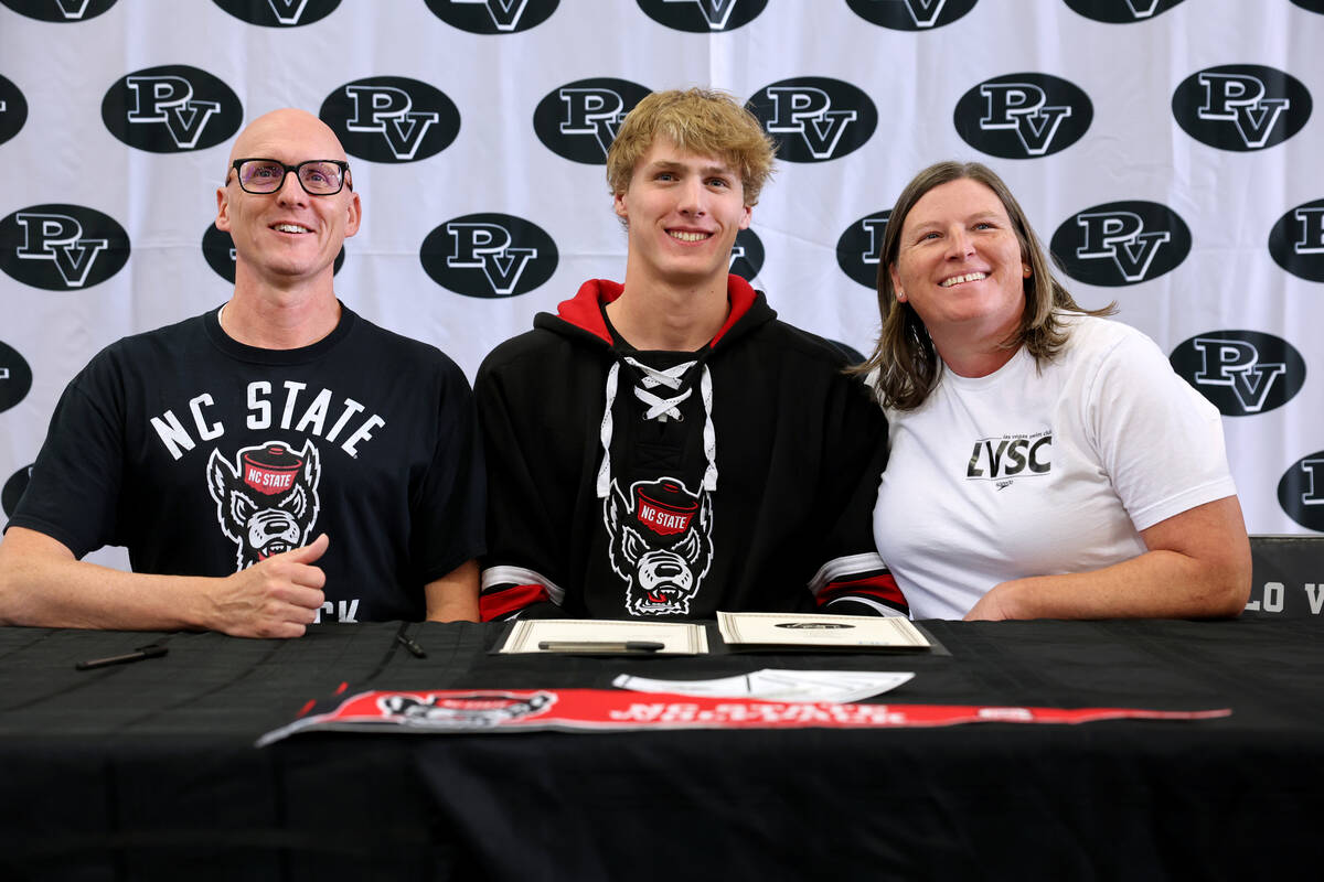 Palo Verde swimmer Max Carlsen prepares to sign a financial aid agreement for North Carolina St ...