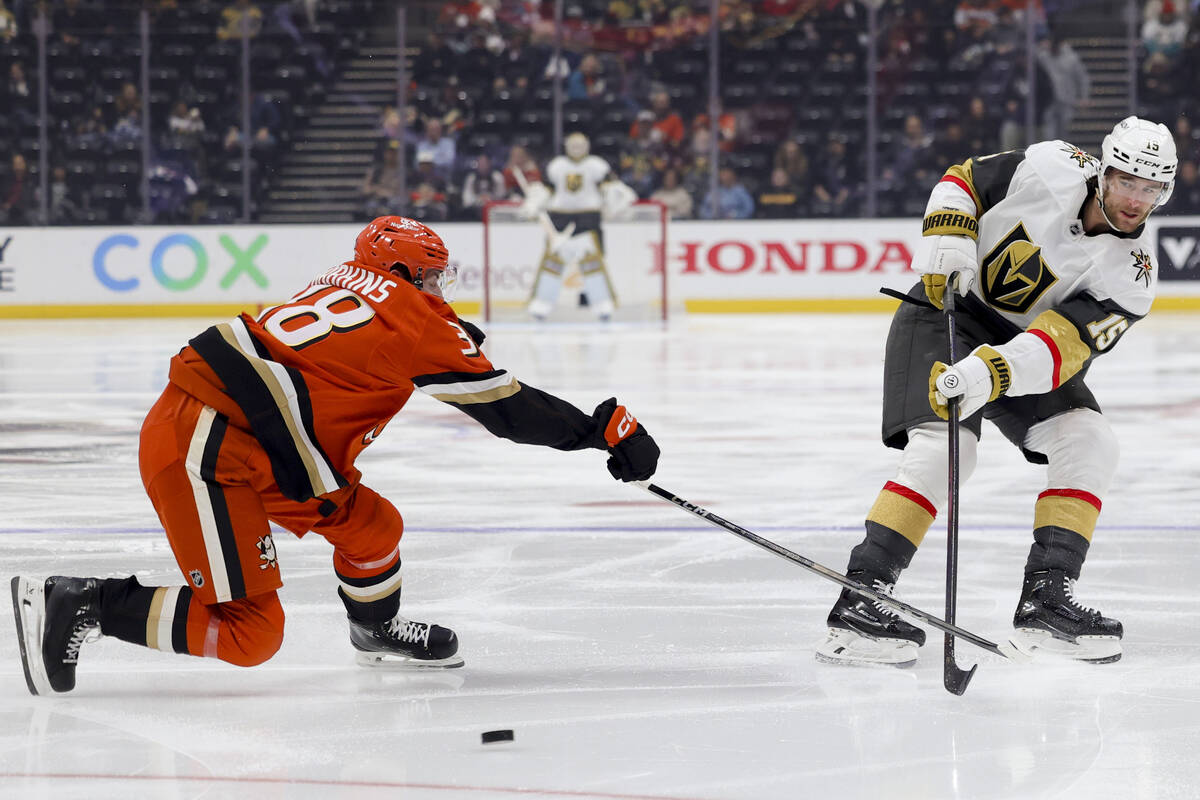 Vegas Golden Knights defenseman Noah Hanifin, right, and Anaheim Ducks centre Jansen Harkins vi ...