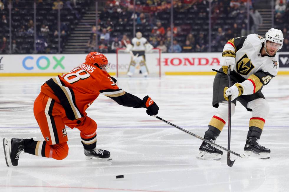 Vegas Golden Knights defenseman Noah Hanifin, right, and Anaheim Ducks centre Jansen Harkins vi ...