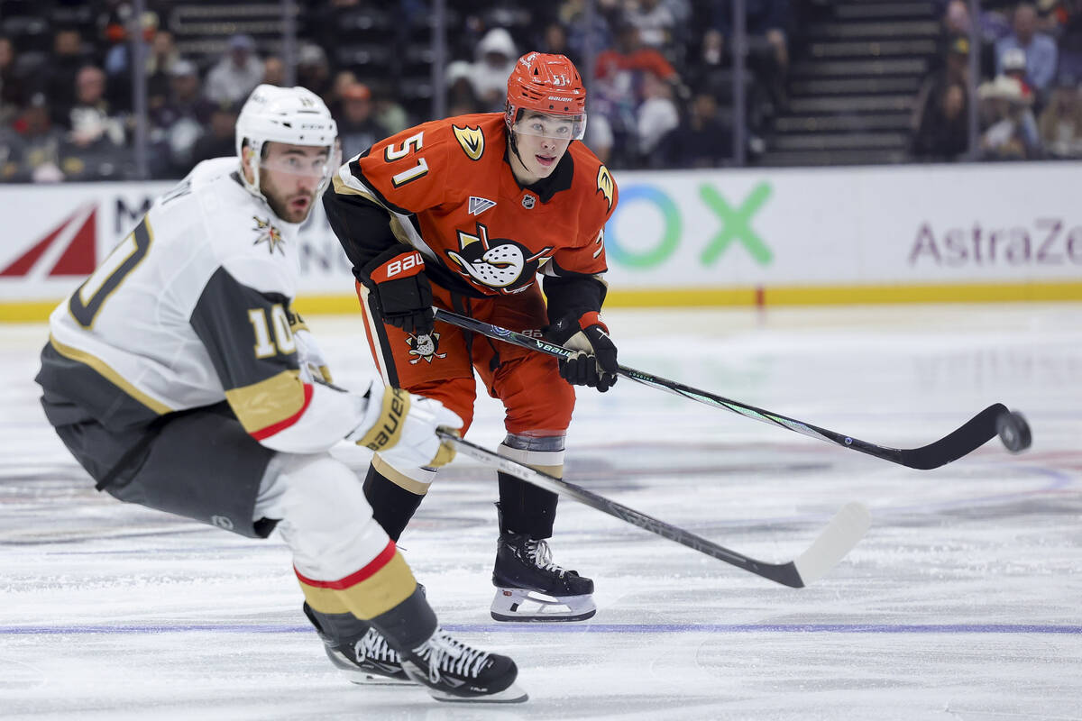 Anaheim Ducks defenseman Olen Zellweger, right, watches his pass next to Vegas Golden Knights c ...