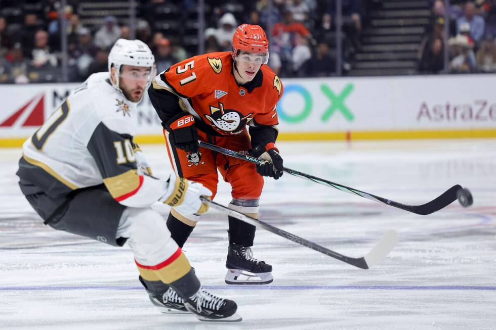 Anaheim Ducks defenseman Olen Zellweger, right, watches his pass next to Vegas Golden Knights c ...