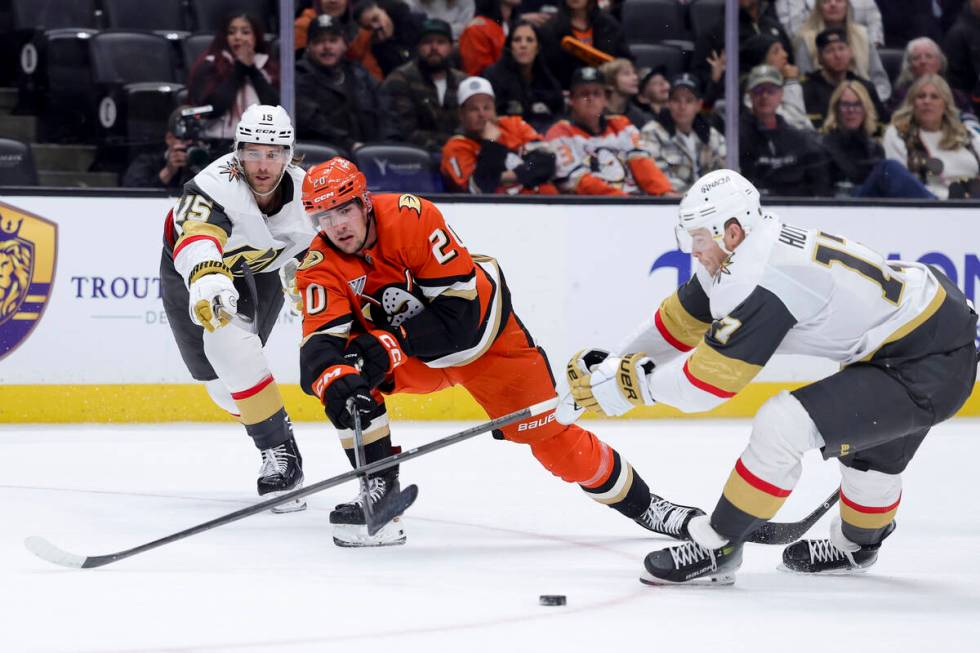 Anaheim Ducks right wing Brett Leason, center, passes the puck past Vegas Golden Knights defens ...