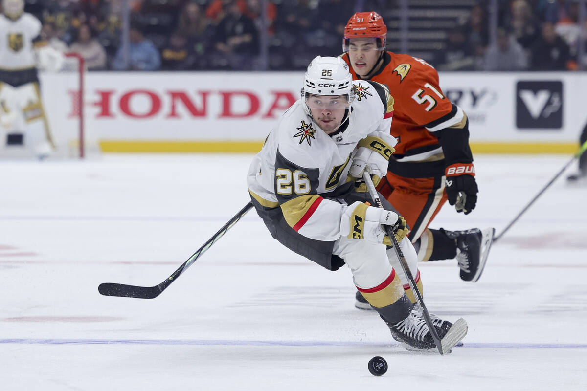 Vegas Golden Knights right wing Alexander Holtz, left, and Anaheim Ducks defenseman Olen Zellwe ...