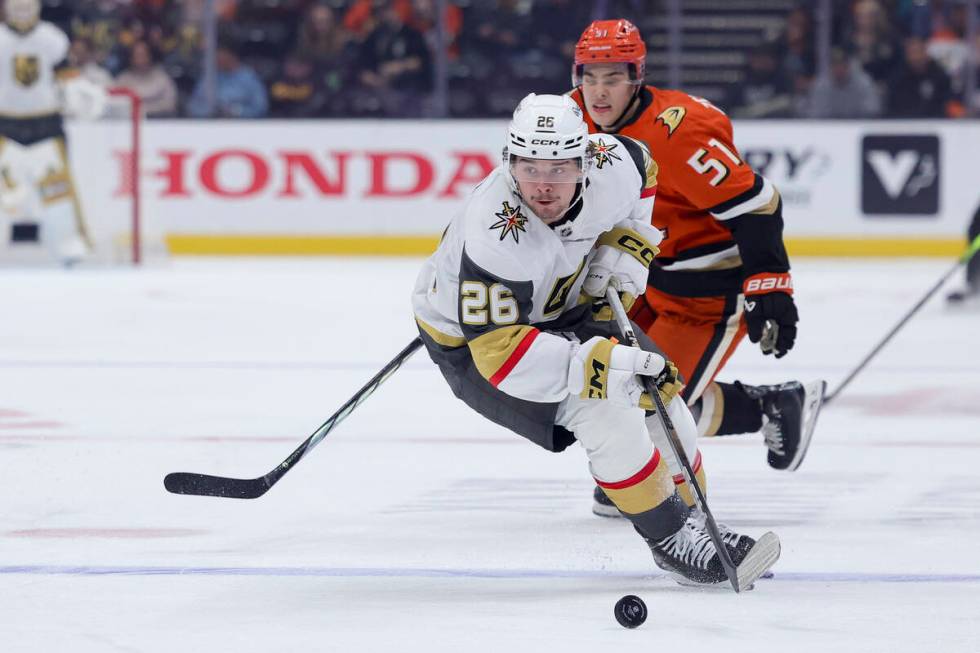 Vegas Golden Knights right wing Alexander Holtz, left, and Anaheim Ducks defenseman Olen Zellwe ...