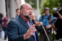 Right-wing conspiracy theorist Alex Jones speaks to the media after arriving at the federal cou ...