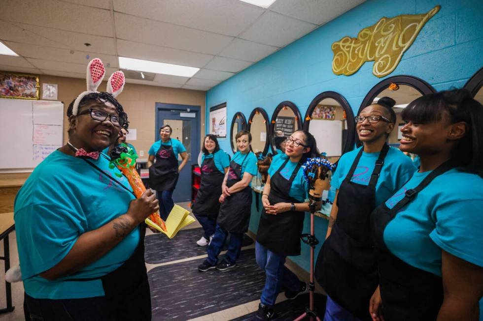 Maalika Dabney, left, has a laugh with fellow inmates during a cosmetology class at Florence Mc ...