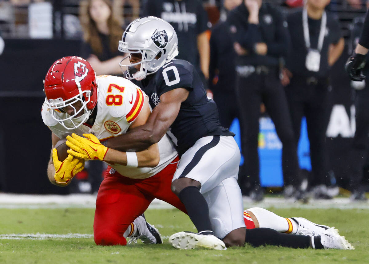 Kansas City Chiefs tight end Travis Kelce (87) is taken down by Raiders cornerback Jakorian Ben ...