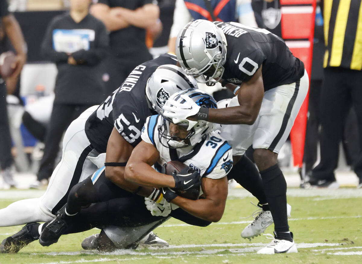 Raiders linebacker Amari Gainer (53) and cornerback Jakorian Bennett (0) take down Carolina Pan ...