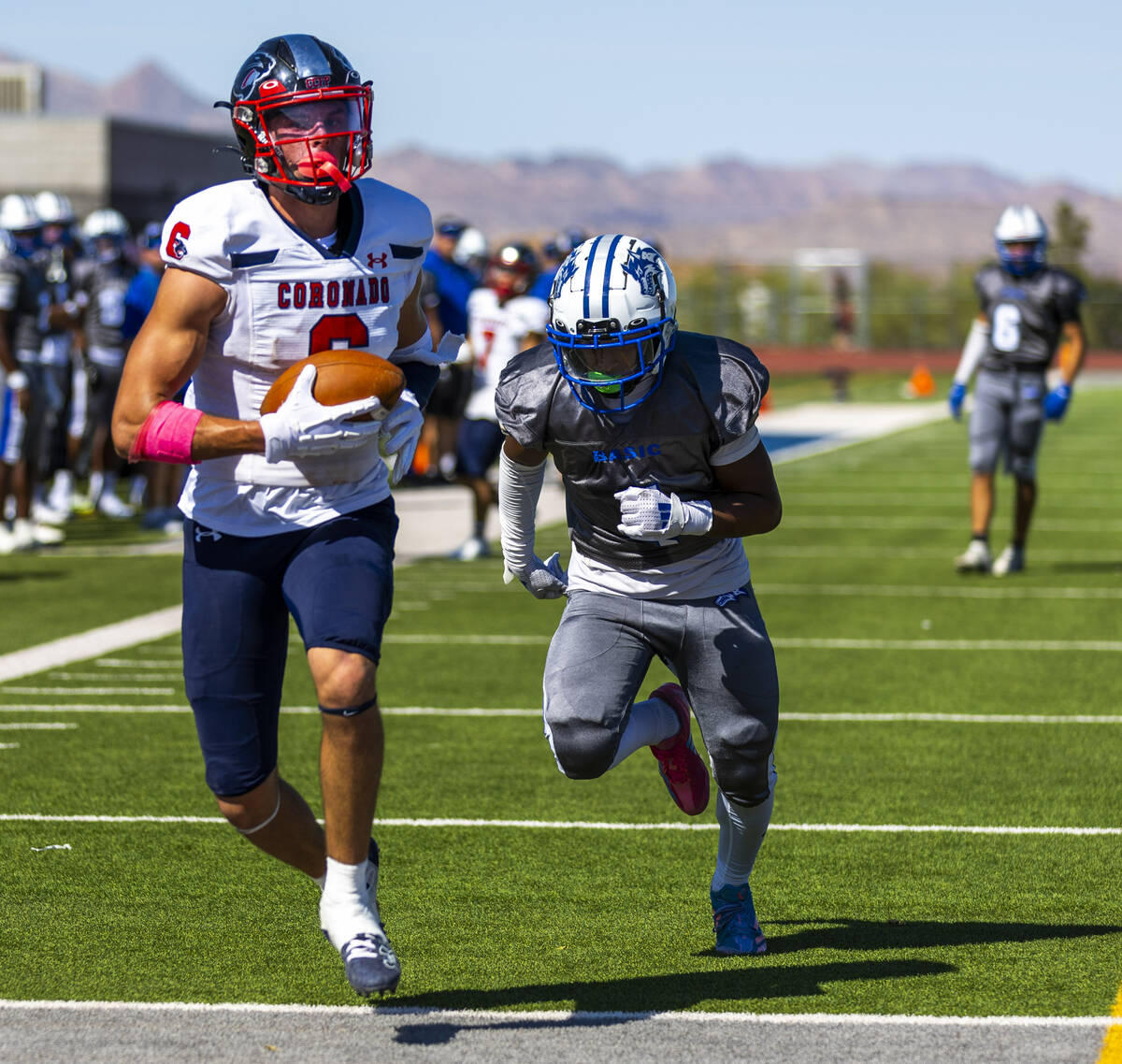 Coronado wide receiver JJ Buchanan (6) runs into the end zone after a catch as Basic defensive ...