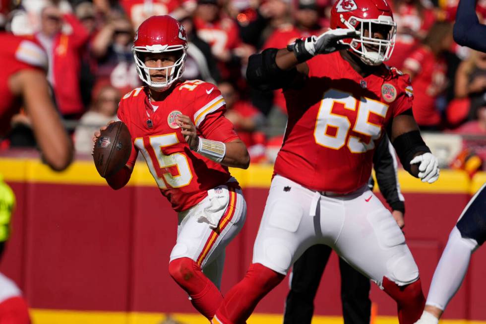 Kansas City Chiefs quarterback Patrick Mahomes (15) look to pass during a game against the Denv ...