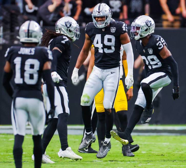 Raiders defensive end Charles Snowden (49), cornerback Nate Hobbs (39) and safety Tre'von Moehr ...