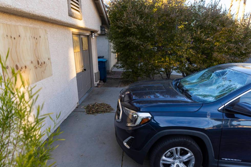 A smashed windshield is seen outside of the home of Brandon Durham, who was shot and killed by ...