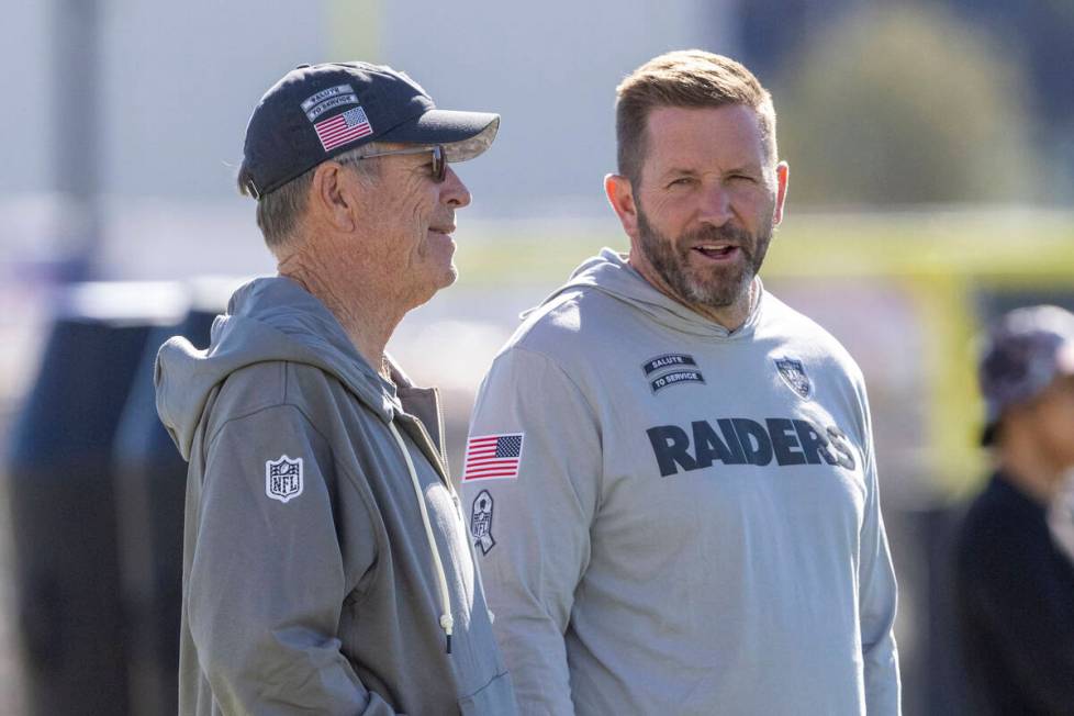 Raiders interim offensive coordinator Scott Turner, right, speaks with his father and senior of ...