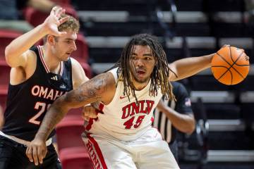 Omaha Mavericks forward Joshua Streit, left, and UNLV forward Jeremiah Cherry (45) compete duri ...