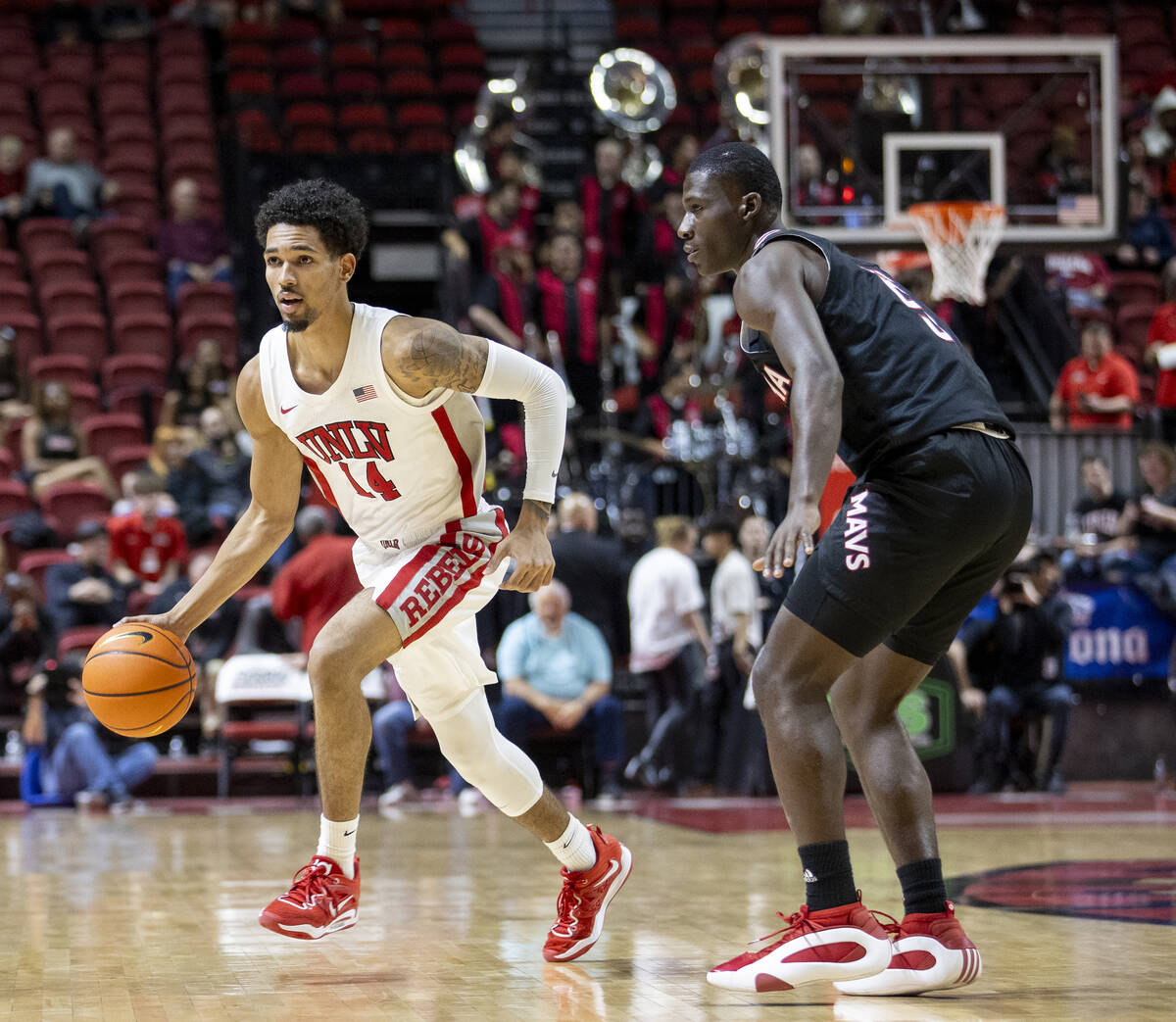 UNLV guard Jailen Bedford (14) dribbles around Omaha Mavericks guard Ja'Sean Glover (5) during ...