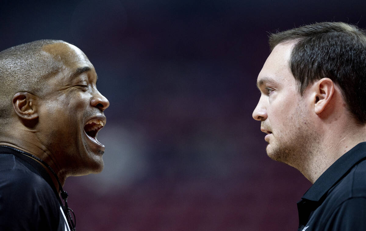 UNLV head coach Kevin Kruger, right, talks to a referee during the college basketball game agai ...