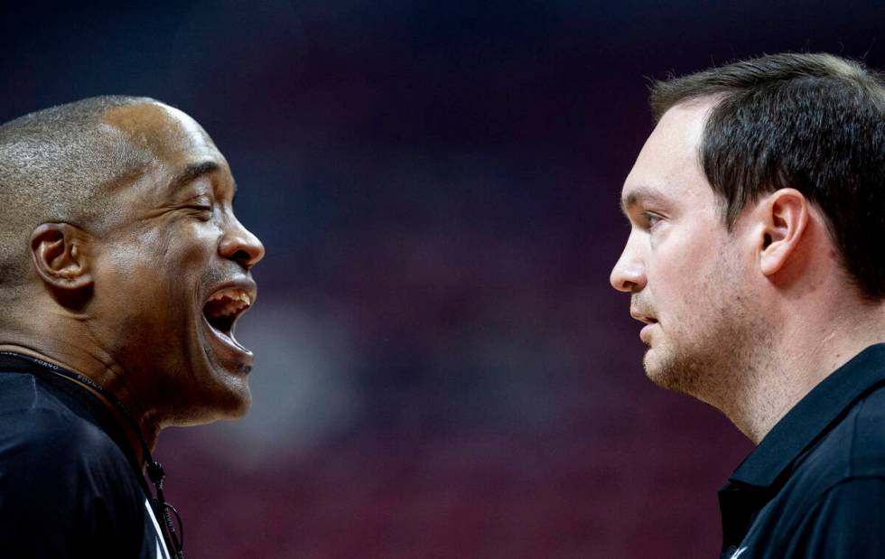 UNLV head coach Kevin Kruger, right, talks to a referee during the college basketball game agai ...