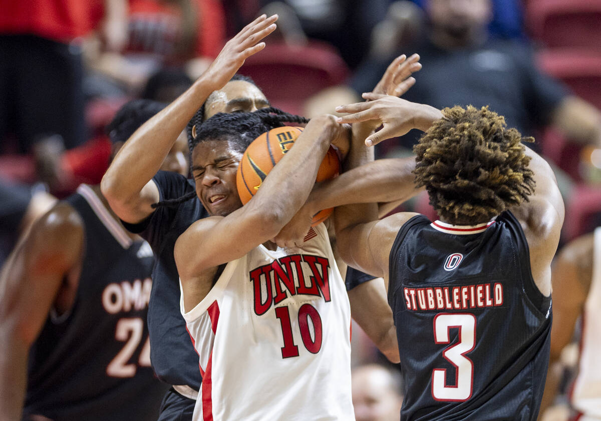 UNLV guard Dedan Thomas Jr. (11) holds his mouth after being elbowed in the face by Omaha Maver ...